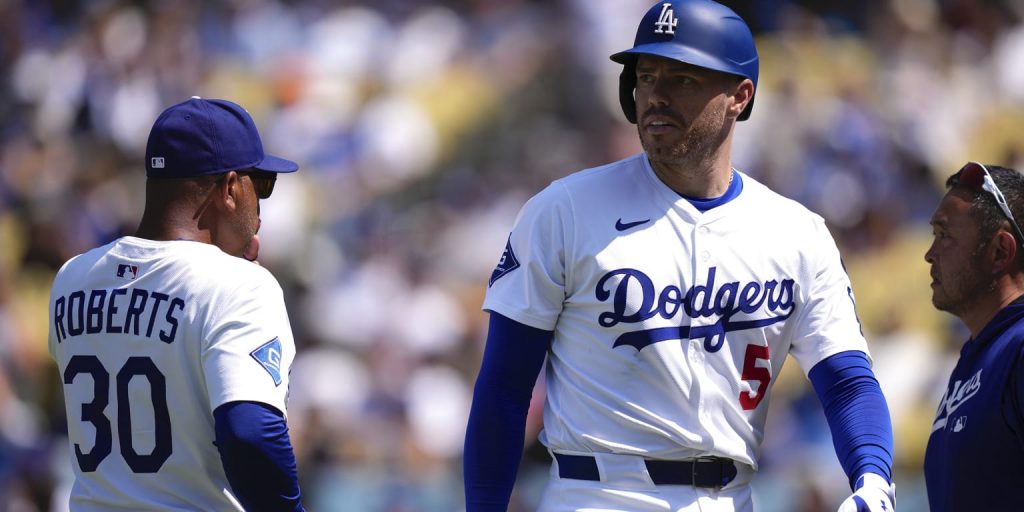 Freeman exits after taking a pitch off his left wrist