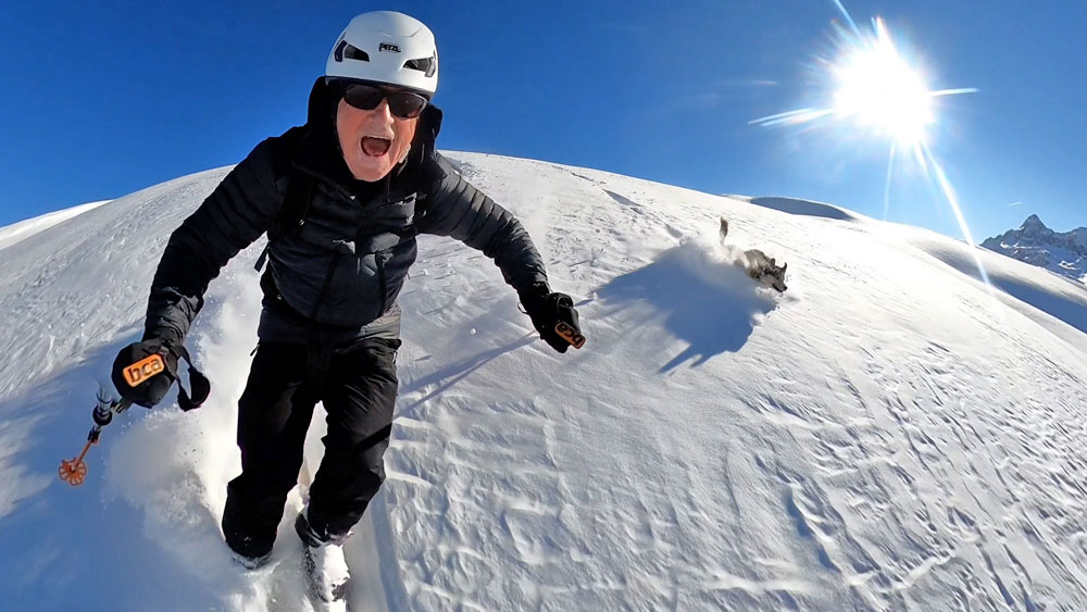 Backcountry ski touring with your dog in powder after a Retour d'Est