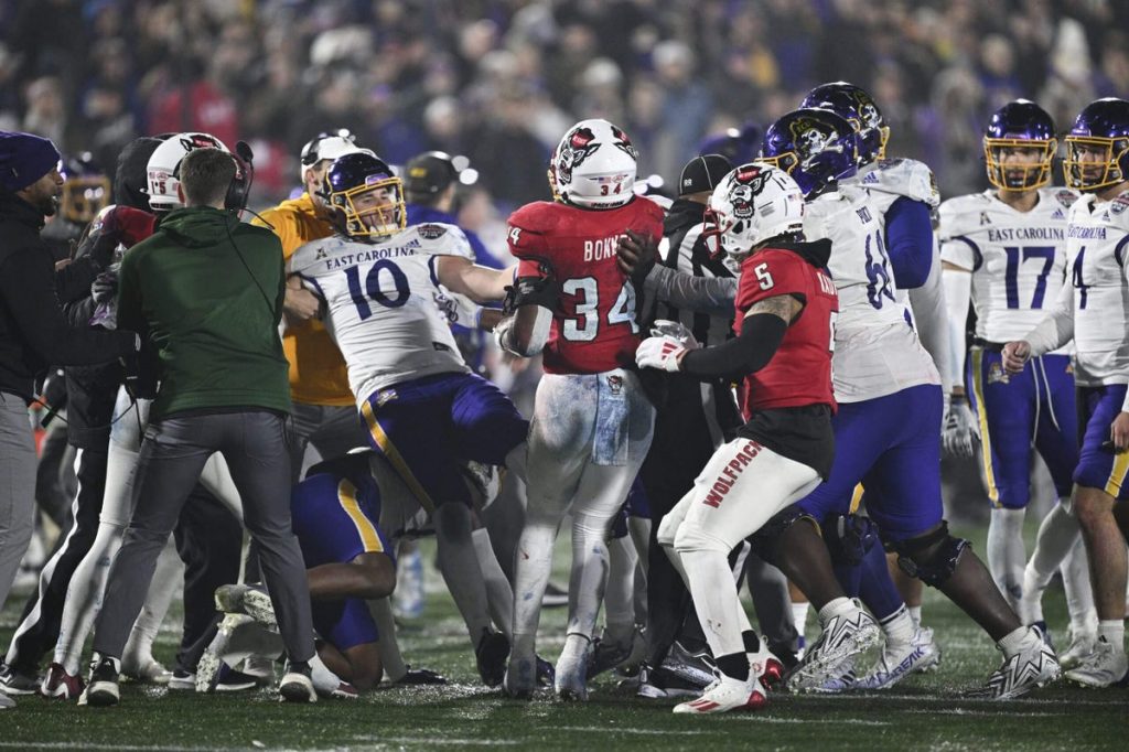 Eight players ejected in ECU-NC State Military Bowl after brawl leaves official bleeding